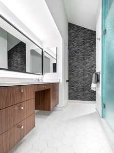 a bathroom with two sinks and a large mirror on the wall next to a walk in shower