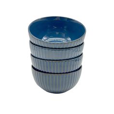 three blue and white bowls stacked on top of each other in front of a white background