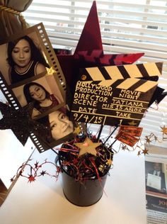 a bunch of pictures are placed on top of a movie clapper and some tinsel