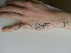 a woman's hand with a tattoo on it