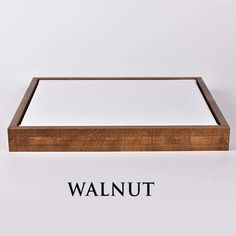 a wooden frame with the word walnut in black writing on it and an image of a white background