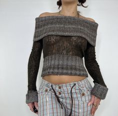 a woman in plaid pants and off the shoulder sweater with her hands on her hips