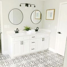 a bathroom with two sinks and mirrors on the wall