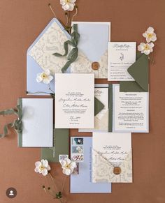 the wedding stationery is laid out on top of each other