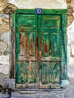 an old green door with the number 10 on it