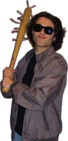 a man holding a baseball bat in his hand and wearing sunglasses on top of it