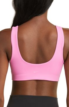 Get into the zone on and off the pickleball court wearing this stretchy, minimalist sports bra with a tonal logo on the back. Elasticized straps Lined 80% polyester, 20% spandex Machine wash, line dry Imported Nike Sports Bra With Built-in Bra For Yoga, Nike Yoga Sports Bra With Built-in Bra, Nike Sports Bra With Built-in Bra For Training, Seamless Sports Bra With Medium Support, Solid Color Moisture-wicking Scoop Neck Sports Bra, Athleisure Activewear With Padded Racerback, Yoga Activewear Racerback With Padded Back, Padded Back Stretch Sports Bra, Athleisure Activewear With Padded Back For Training