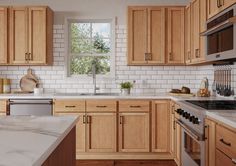 a kitchen filled with wooden cabinets and white counter tops next to a stove top oven