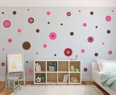 a child's bedroom with pink and brown polka dot wall decals