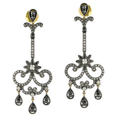 This stunning flower-style earring is made with 18k gold and silver and features a pave set of diamonds. The earring is expertly crafted to showcase the beauty of the diamonds and the intricate design of the flower. The combination of 18k gold and silver gives the earring a luxurious and sophisticated look, while the diamonds add a touch of sparkle and elegance. This earring is the perfect accessory to dress up any outfit for a special occasion or to add a touch of glamour to your everyday style Fine Jewelry Diamond Chandelier Earrings, Diamond Chandelier Earrings For Pierced Ears, Luxury Diamond Dangle Earrings With Pave Setting, Luxury Pave Set Diamond Dangle Earrings, Luxury Pierced Chandelier Earrings For Anniversary, Luxury Bridal Rose Cut Diamond Drop Earrings, Luxury Drop Earrings With Single Cut Diamonds, Luxury Single Cut Diamond Drop Earrings, Exquisite Earrings With Pave Setting For Evening