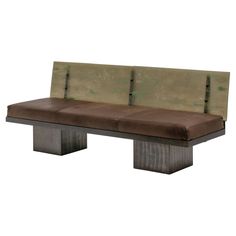 a bench made out of wood and leather with two benches on each side, facing the same direction