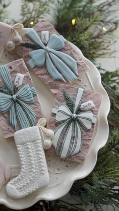 decorated cookies are sitting on a platter with stockings and stocking hanging from it