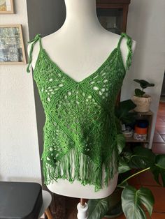 Women's handmade crochet boho style top in granny square with pretty trendy green fringe for summer size 36 Bohemian Spring Tank Top With Crochet Trim, Spring Bohemian Tank Top With Crochet Trim, Summer Green Crochet Top, Bohemian Sleeveless Crochet Top For Summer, Sleeveless Bohemian Crochet Top For Summer, Green Bohemian Crochet Dress For The Beach, Green Bohemian Crochet Dress For Beach, Hippie Summer Tops With Tassels, Spring Bohemian Crochet Top With Granny Square