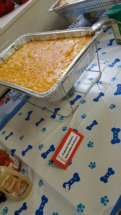 a table topped with lots of food on top of a blue and white table cloth