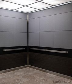 an empty room with two metal partitions on the wall