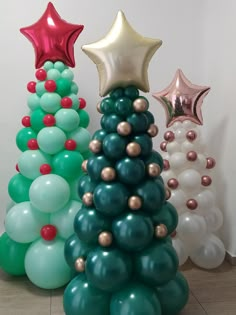 three christmas trees made out of balloons