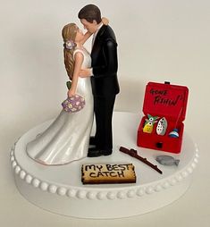 a wedding cake topper with a bride and groom