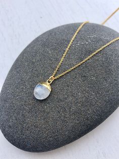 Rainbow Moonstone Necklace, June Birthstone, Tiny Moonstone Pendant, Minimalist Jewelry, Layering Jewelry, Gift for her, Fertility Crystal This simple dainty necklace features a tiny genuine rainbow moonstone pendant dipped in 14k Gold Filled. The white moonstone pendant is suspended from a delicate 14k gold filled cable chain. This is a 100% natural moonstone gemstone, full of healing properties. This necklace is simply perfect for everyday wear and is perfect for layering with other pieces in Minimalist Moonstone Crystal Necklace With Gemstone, Everyday Moonstone Necklace, Minimalist Necklace With Moon Charm For Healing, Minimalist Moon Shaped Gemstone Necklace, Minimalist Moonstone Necklace With Moon Charm, Minimalist Moonstone Round Necklace, Minimalist Moonstone Jewelry With Moon Charm, Minimalist Moonstone Necklace With Moon Phase, Bridal Party Jewelry Sets