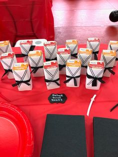 a table topped with lots of black and white paper wrapped in twine on top of each other