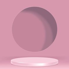 a round object on a pink background with a white base and light reflection in the center