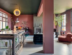 a living room filled with furniture and lots of windows