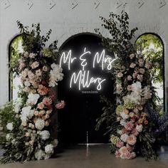 the entrance to mr and mrs miller's wedding venue with flowers on either side