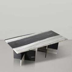 a black and white marble coffee table sitting on top of a gray floor