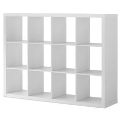 a white bookcase with eight cubes on the front and four shelves below it