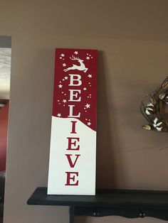 a red and white sign that says believe on it