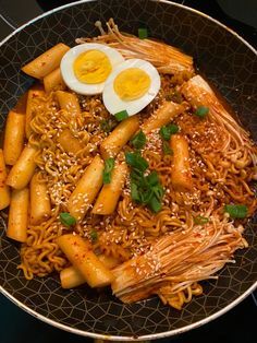 noodles and eggs are served in a bowl