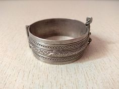 A superb old Berber silver bracelet from Morocco. The surface of the bangle has been finely hand-etched with a design combining lines, and the surface as well as interior have both obtained a very rich patina from wear and usage. It opens and closes with a pin. Inner diameter : 5,5 cm (2,16 inches) Width : 2,4 cm (0,9 inches) Weight : 54,7 g Engraved Antique Silver Bangle, Traditional Engraved Sterling Silver Bracelet, Traditional Engraved Sterling Silver Round Bracelet, Traditional Engraved Sterling Silver Bracelet For Ceremonial Use, Traditional Silver Stamped Bangle, Ornate Stamped Bangle Bracelet, Traditional Stamped Bracelets, Traditional Silver Stamped Bracelets, Traditional Silver Stamped Bracelet