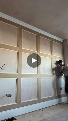 a man is painting a garage door with white paint on the inside and side walls