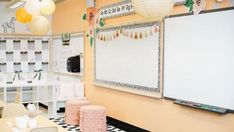 a room with tables, chairs and a white board