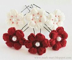 three crocheted flowers with pearls on them are shown in red and white colors