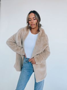 DETAILS: Our Almond Faux Fur Jacket is a comfy and cozy jacket that is the perfect piece to keep you warm. This jacket has a drapped open front look to it. The jacket has a longer fit to it and also has side pockets. The inside of this item has a soft lining. CONTENT & CARE: SELF: 50% Rayon, 25% Nylon, 25% Polyester. SIZE & FIT: Model is 5'6" The model is wearing a size Small. Fits true to size The Fabric has stretch Soft Textured Outerwear For Fall, Soft Hooded Fall Outerwear, Casual Soft Winter Outerwear, Casual Long Sleeve Soft Outerwear, Soft Hooded Winter Outerwear, Hooded Soft Outerwear For Winter, Oversized Beige Comfortable Outerwear, Chic Long Sleeve Outerwear With Soft Texture, Cozy Fur Coat For Cold Fall Weather