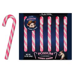 four pink and white striped candy canes in a package with an ad for possum