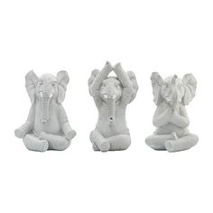 three small white elephants sitting on top of each other in front of a white background