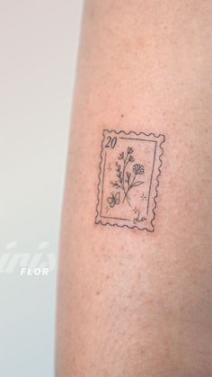 a stamp with some flowers on it and the word love is written in black ink