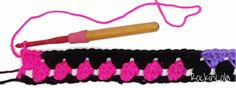 a crochet hook with pink and purple beads