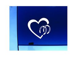 a white heart with two intertwined hands on a blue background sticker in front of a window