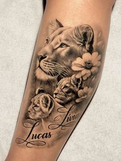 a woman's leg with a tattoo on it that says lucas and two lions