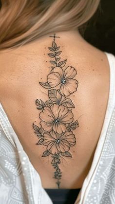 the back of a woman's neck with flowers on it