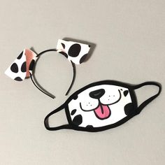 a pair of black and white dalmatian headbands with ears on them