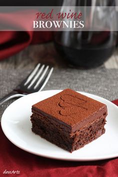 a piece of chocolate cake sitting on top of a white plate next to a fork