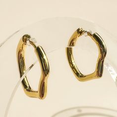 Fluid, organic shaped hoops that look understated but are anything but. These have a hinged leverback closure to keep 'em seamless (and comfy!). We especially love wearing the two sizes together on each ear for an effortlessly cool pairing. Available in 2 sizes: small (16mm) and medium (18mm). Our materials make for an amazing, high quality, seamless, jewelry piece with longevity. Our earrings are plated with 18k gold, 18k rose gold, or rhodium and finished with a protective coating. A little se Modern Metal Huggie Earrings For Everyday, Adjustable Small Hoop Modern Huggie Earrings, Adjustable Modern Small Hoop Huggie Earrings, Modern Clip-on Hoop Earrings For Everyday, Modern Adjustable Nickel-free Huggie Earrings, Everyday Small Hinged Hoop Earrings, Everyday Metal Huggie Earrings, Modern Adjustable Huggie Earrings For Pierced Ears, Adjustable Modern Huggie Earrings