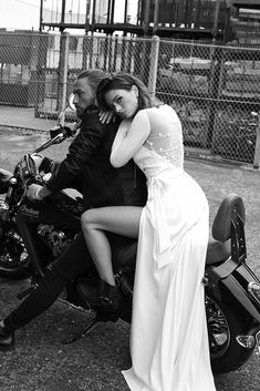 a man and woman are sitting on a motorcycle