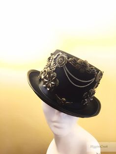 "Neo-Victorian top hat combining a vintage Victorian style with subtle eccentricity of mechanical aesthetic of steampunk, this unisex top hat is fitted with a variety of Victorian vintage baubles and fantastical cogs & gear ornaments on a formed Felt hat with with Ribbon Band. Choosing the custom theme Hat option? Whether you are a high-society aristocrat, a brilliant Steam engineer or a greasy Steam-machine mechanic, your customized hat will work wonderfully with almost any ensemble. S I Z Mechanical Aesthetic, Steampunk Hats, Elegant Face Mask, Victorian Top, Victorian Hats, Steampunk Hat, Fascinator Hairstyles, Style Steampunk, Steampunk Wedding