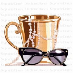 a golden cup with sunglasses and pearls on it