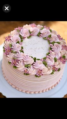 a cake decorated with pink flowers on top of a white plate