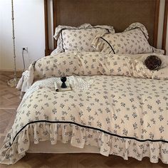 a bed with white and black bedspread, pillows and pillow cases on it